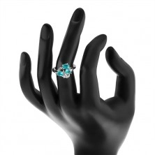 Trblietavý prsteň striebornej farby, zvlnená línia, tri ovály akvamarínovej farby