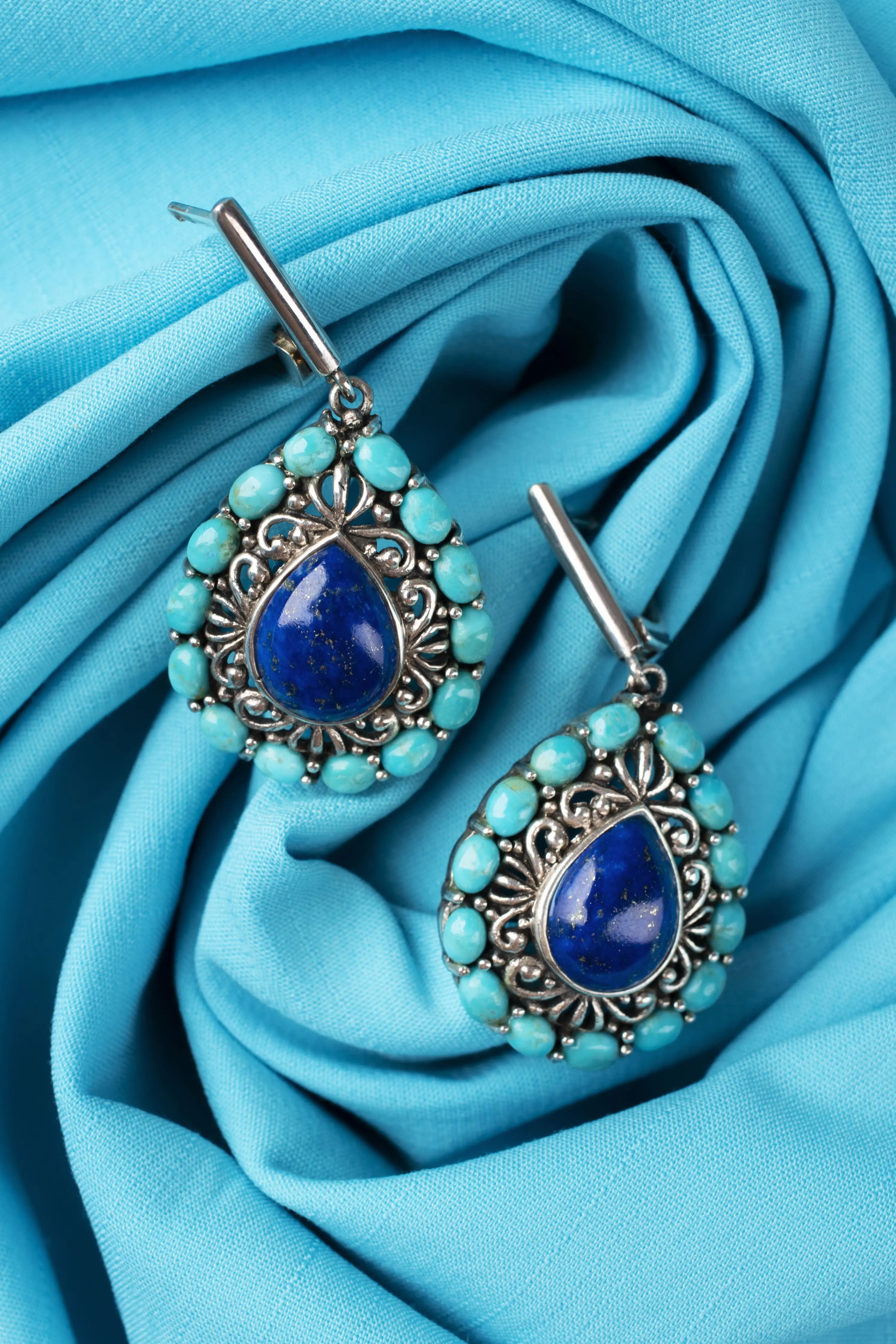 Сребърни обеци със сини камъни на син фон